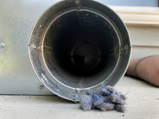 Bridgeport Dryer Vent Cleaning technician using specialized equipment to clear severe dryer vent blockage in Bridgeport